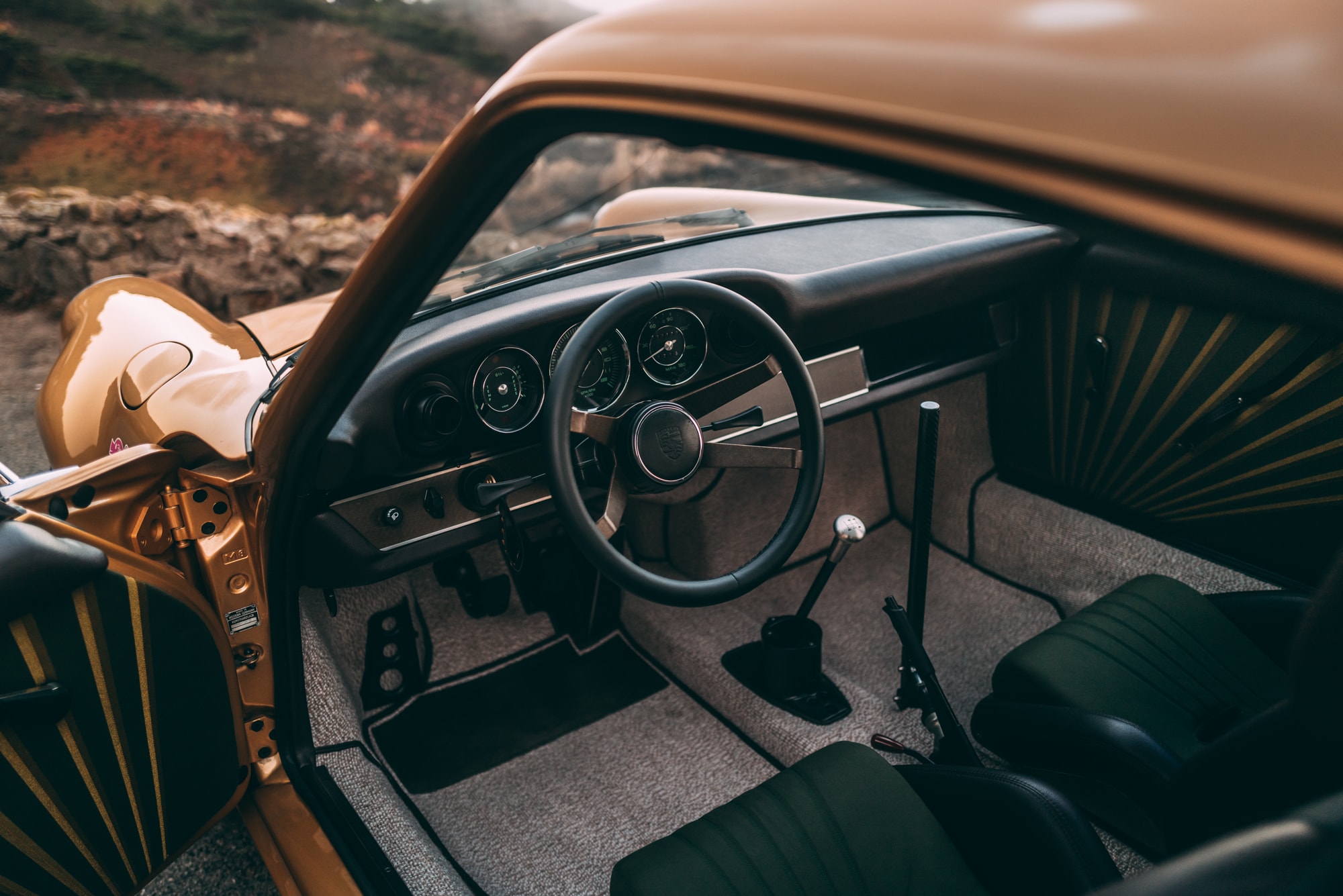 Interior of a 911K with striped door cards and a carbon fiber steering wheel